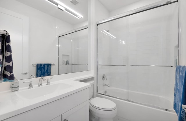 bathroom featuring vanity, toilet, visible vents, and bath / shower combo with glass door