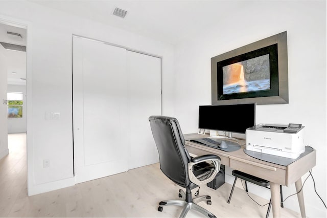 office featuring light wood-style floors and visible vents