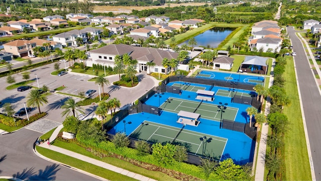 drone / aerial view featuring a residential view and a water view