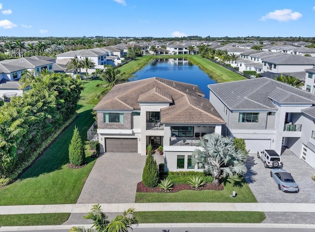 birds eye view of property with a residential view and a water view