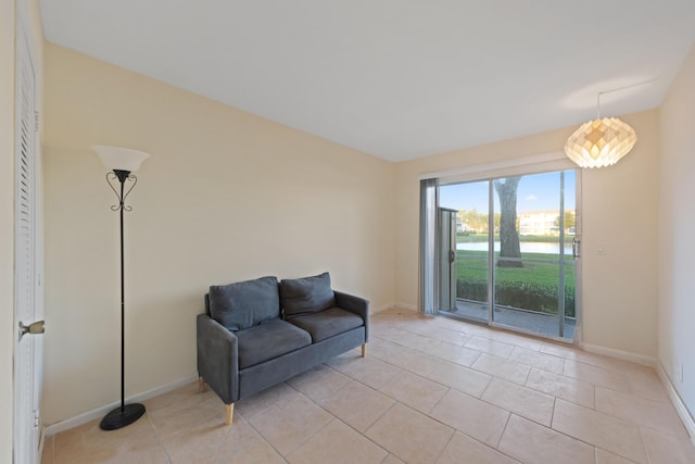 sitting room with baseboards and light tile patterned flooring