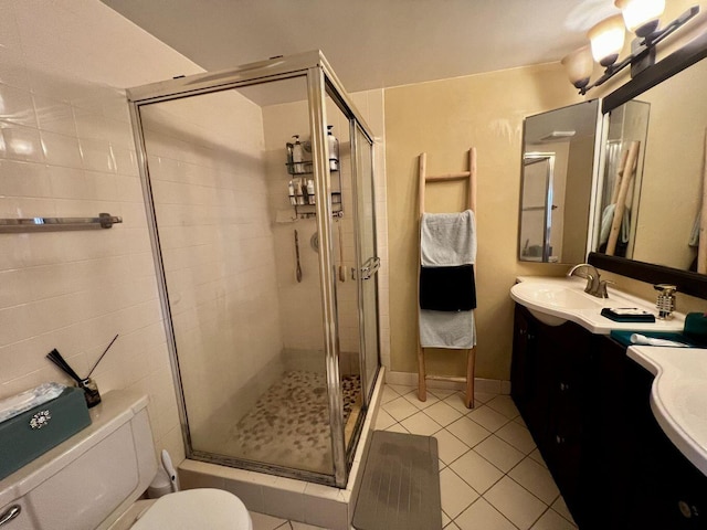 full bathroom with a stall shower, tile patterned flooring, a sink, and toilet