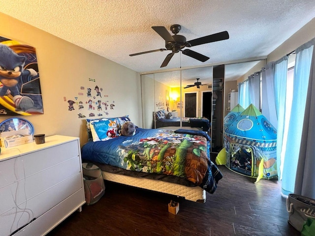 bedroom featuring ceiling fan, a textured ceiling, and wood finished floors