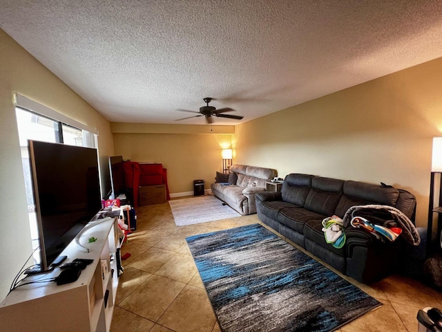 living area with light tile patterned floors, ceiling fan, and a textured ceiling