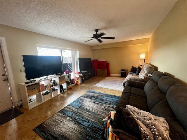 tiled living area featuring ceiling fan and a textured ceiling