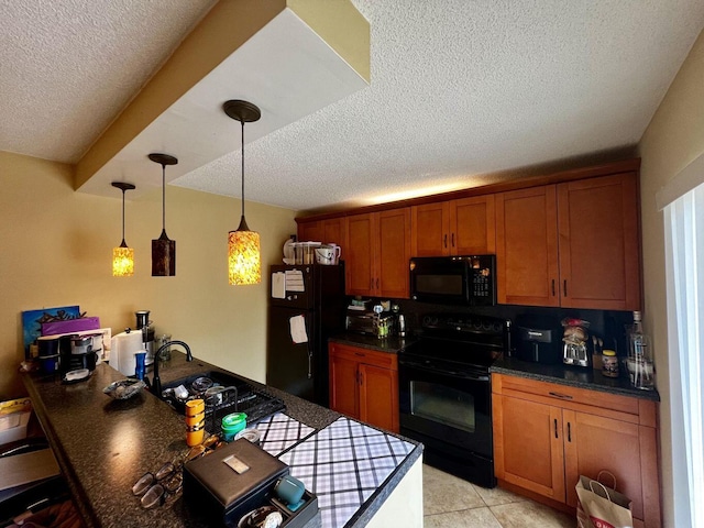 kitchen featuring brown cabinetry, dark countertops, a sink, and black appliances