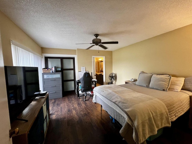 bedroom with dark wood-style floors, a ceiling fan, and a textured ceiling