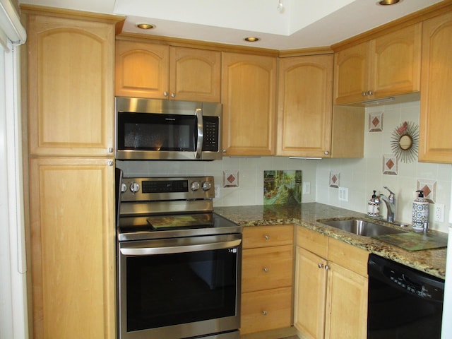 kitchen with stone counters, tasteful backsplash, stainless steel appliances, and light brown cabinetry