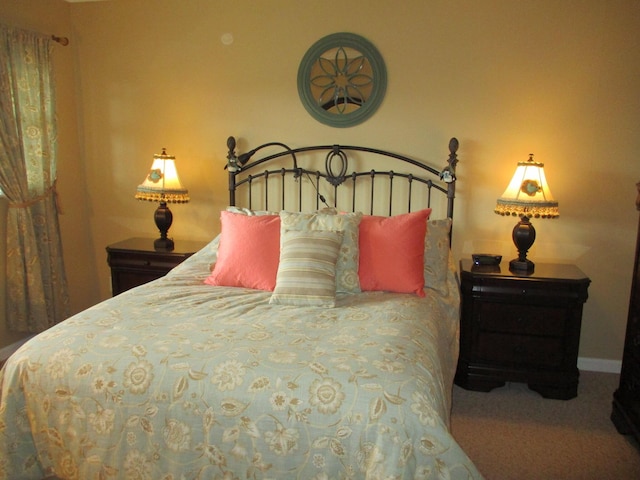 bedroom with carpet flooring and baseboards