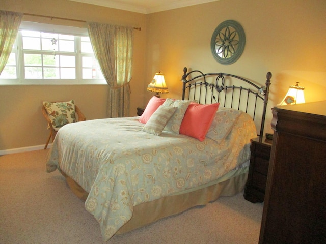 bedroom featuring carpet floors, ornamental molding, and baseboards