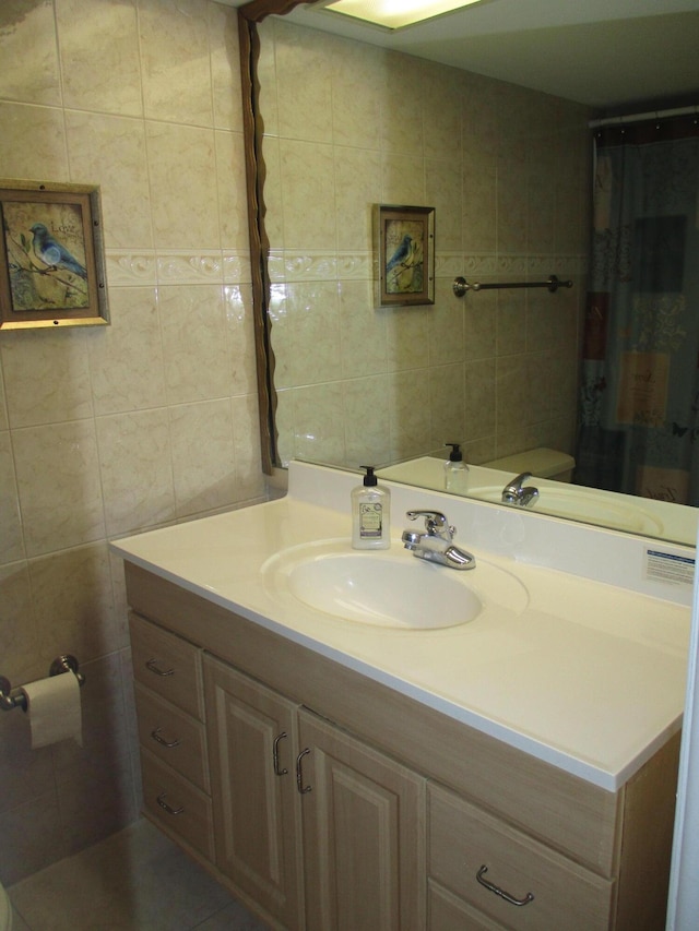 bathroom with vanity and tile walls