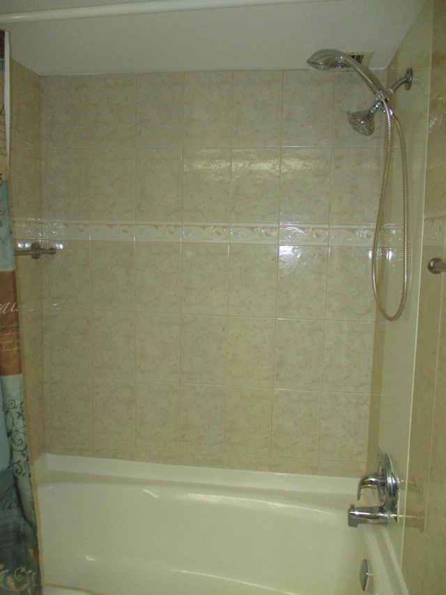 bathroom with shower / bath combo with shower curtain