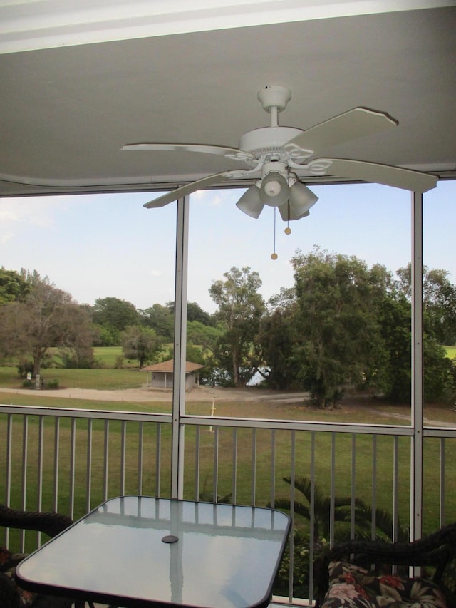 balcony with outdoor dining space and ceiling fan