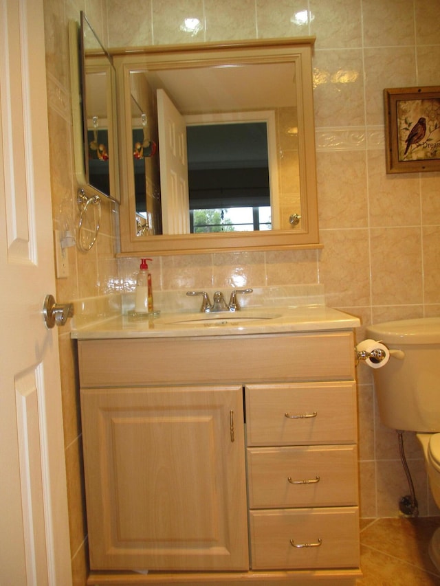 bathroom featuring backsplash, tile walls, toilet, and vanity