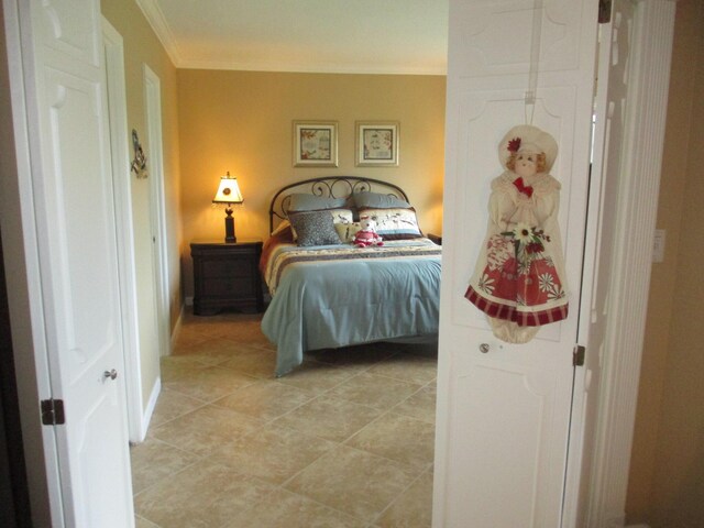 bedroom featuring light tile patterned floors and ornamental molding