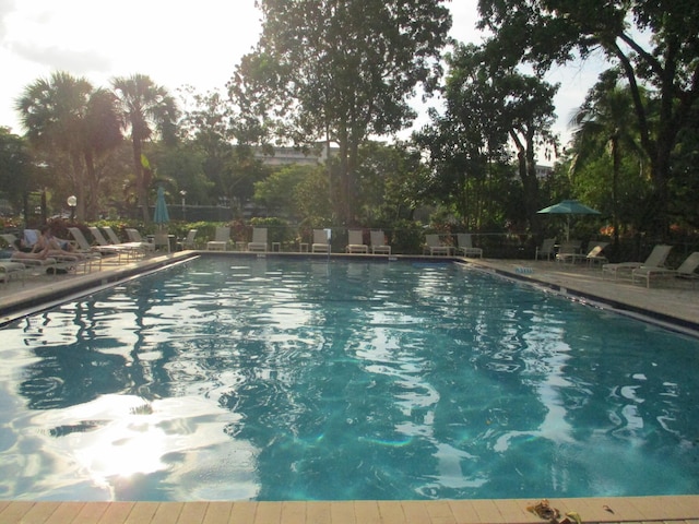 pool with a patio area and fence