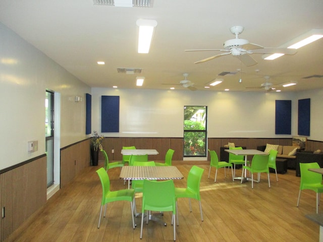 playroom with visible vents, wood finished floors, and wainscoting