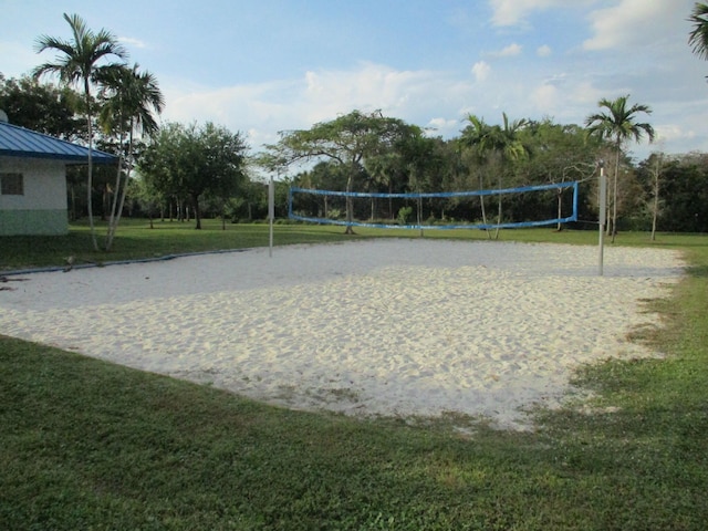 view of home's community featuring a lawn and volleyball court