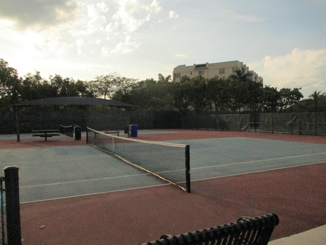 view of tennis court featuring fence