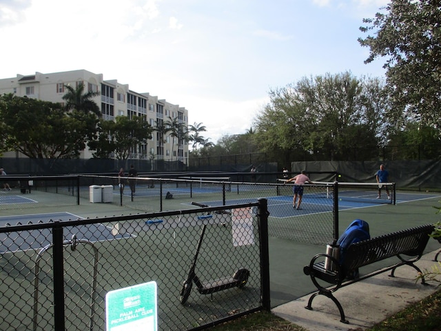 view of sport court featuring fence