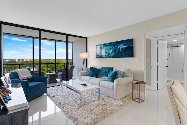 living room featuring baseboards, a wall of windows, and light tile patterned flooring