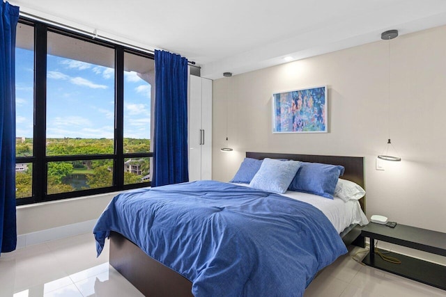 bedroom with tile patterned flooring and baseboards