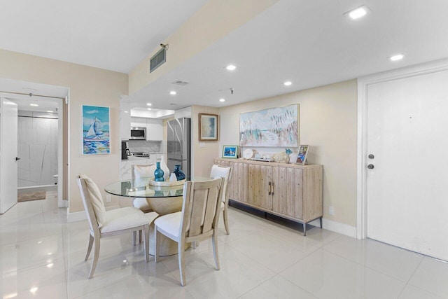 dining space featuring baseboards, visible vents, and recessed lighting