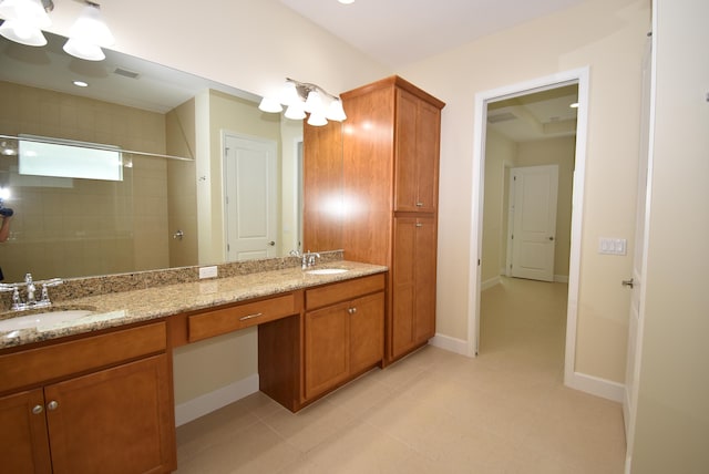 bathroom featuring double vanity, visible vents, a sink, and tiled shower