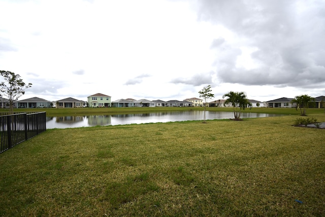 view of water feature featuring a residential view and fence