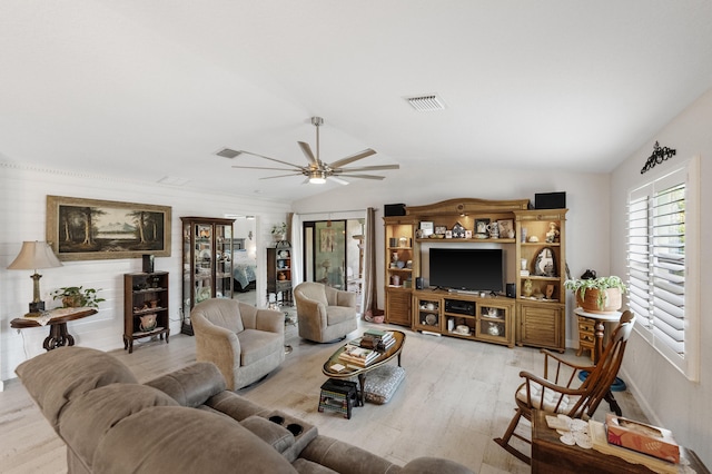 living room with a ceiling fan, visible vents, vaulted ceiling, and wood finished floors