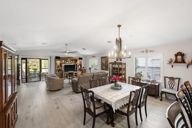 dining space featuring vaulted ceiling, plenty of natural light, and light wood-style flooring