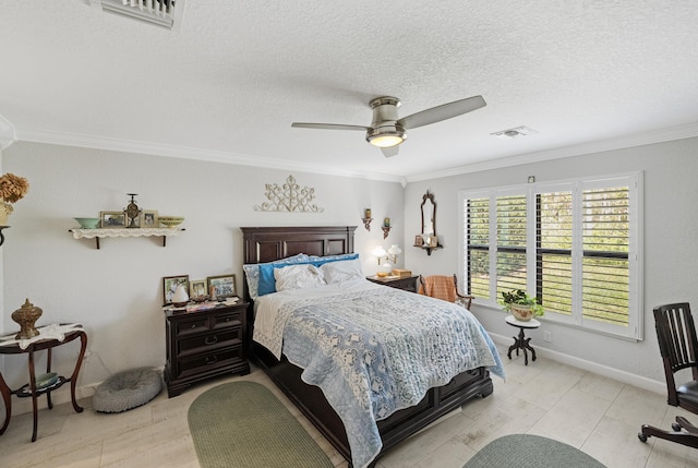 bedroom featuring a textured ceiling, ceiling fan, visible vents, and crown molding