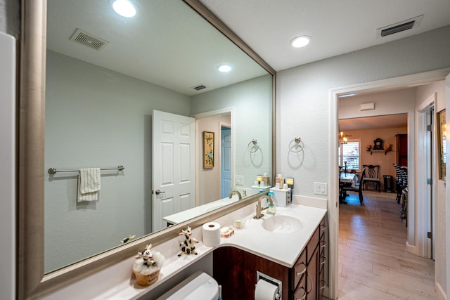 bathroom with vanity, wood finished floors, visible vents, and recessed lighting