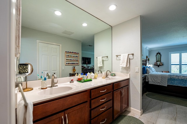 bathroom with ornamental molding, a sink, ensuite bath, and double vanity