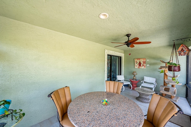 view of patio / terrace featuring a ceiling fan and outdoor dining space