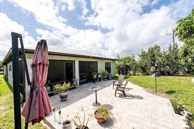 view of patio / terrace featuring a sunroom