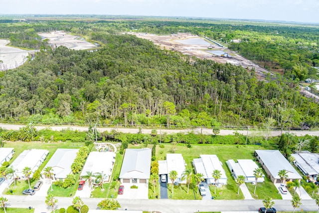 drone / aerial view featuring a residential view and a view of trees