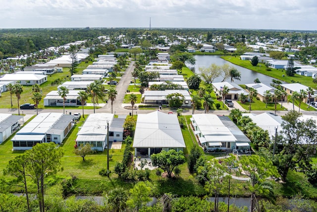 birds eye view of property with a water view and a residential view