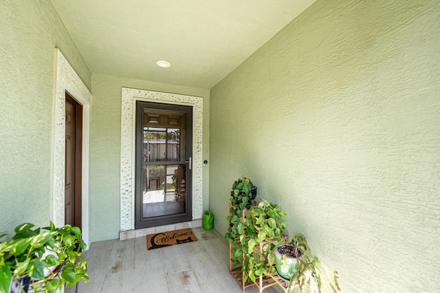 entrance to property with stucco siding