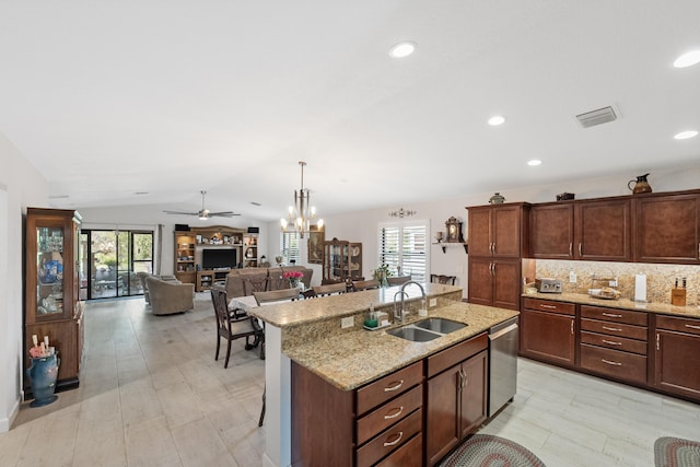 kitchen featuring tasteful backsplash, visible vents, dishwasher, vaulted ceiling, and a sink