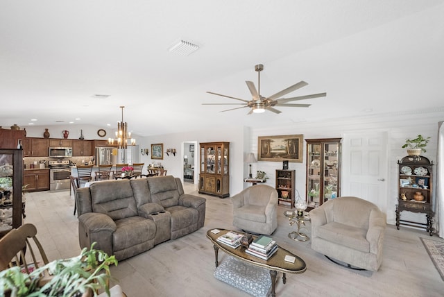 living area with lofted ceiling, visible vents, and ceiling fan with notable chandelier