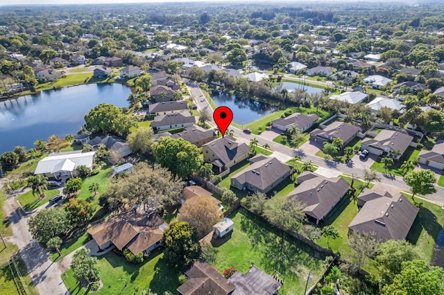 drone / aerial view featuring a residential view and a water view