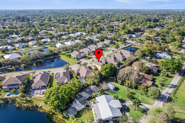 drone / aerial view with a water view and a residential view