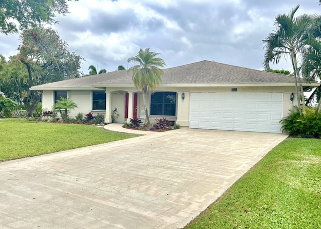 single story home with a garage, driveway, a front lawn, and stucco siding