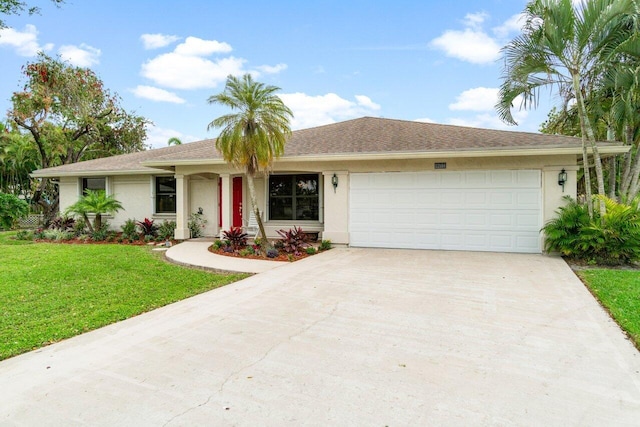 ranch-style house featuring a garage, concrete driveway, a front yard, and stucco siding