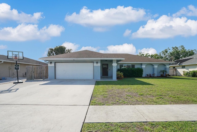 ranch-style home featuring a garage, driveway, fence, a front yard, and stucco siding