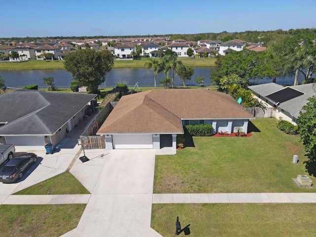 birds eye view of property with a residential view and a water view