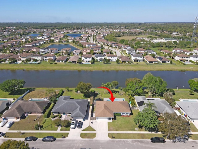 drone / aerial view with a residential view and a water view