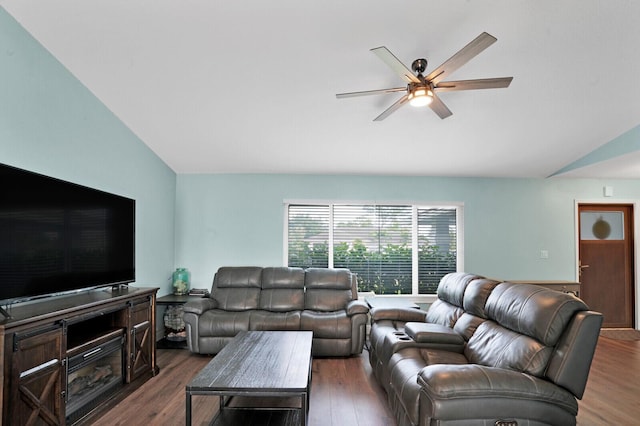 living area featuring wood finished floors, ceiling fan, and vaulted ceiling