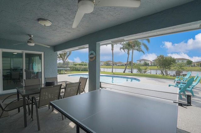 view of patio / terrace featuring a trampoline, a ceiling fan, and an outdoor pool